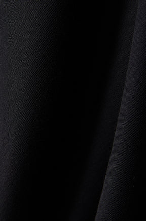 Tissu noir du polo montrant une texture tricot fine et une couture foncée pour homme par Psycho Bunny, en gros plan