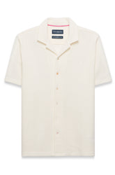 Polo crème texturé à manches courtes, boutons pleine longueur et logo poitrine pour homme par Psycho Bunny, vue avant