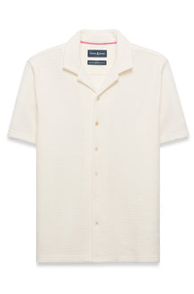 Polo crème texturé à manches courtes, boutons pleine longueur et logo poitrine pour homme par Psycho Bunny, vue avant