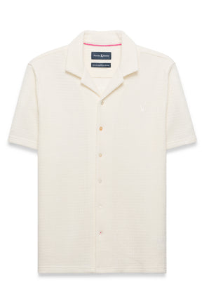 Polo crème texturé à manches courtes, boutons pleine longueur et logo poitrine pour homme par Psycho Bunny, vue avant