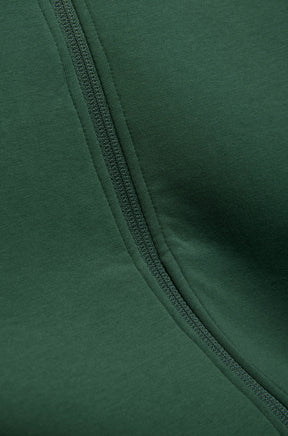 Men's close detail of dark green knit fabric and matching zipper tape on the jacket front by Psycho Bunny