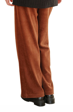 Rien ne se perd, tout se crée women's rust brown corduroy wide-leg pants with straight hems over black shoes, back view