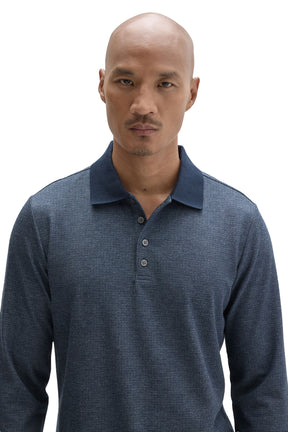 Men's close front detail of blue textured long sleeve polo with dark ribbed collar and gray buttons by Robert Barakett