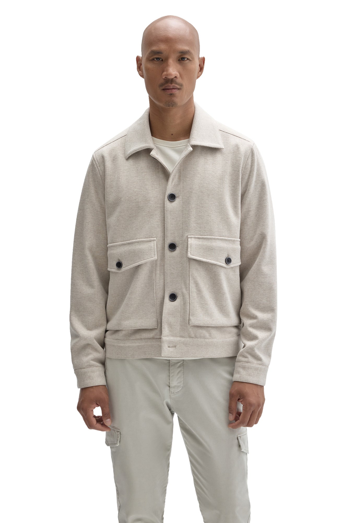Front view of men's cream textured button-front jacket with spread collar and flap patch pockets by Robert Barakett