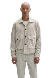 Front view of men's cream textured button-front jacket with spread collar and flap patch pockets by Robert Barakett