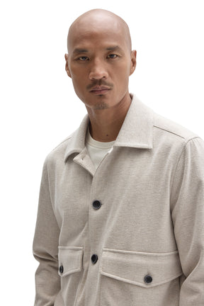 Robert Barakett men's cream textured jacket collar, dark buttons and flap pocket details, close-up