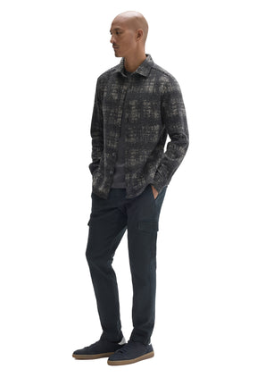 Robert Barakett men's angled full-body view of charcoal plaid overshirt worn open over a dark T-Shirt, side view