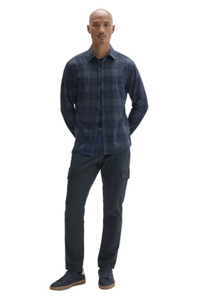 Men's full-body front view of navy plaid long sleeve overshirt worn open over a dark T-Shirt by Robert Barakett