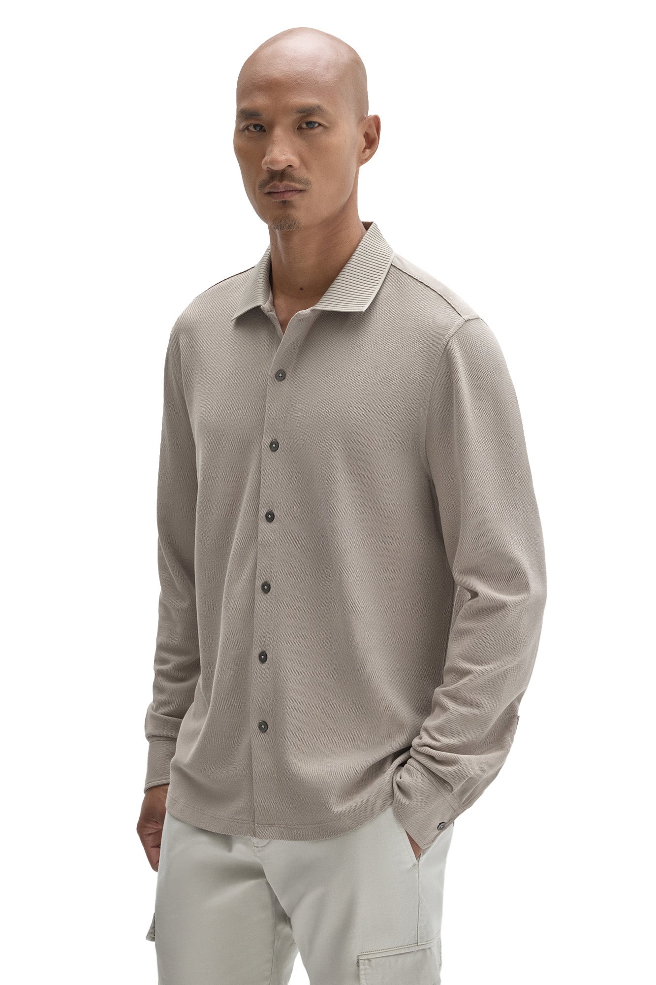 Men's front angled view of a light taupe long sleeve knit button-front shirt with ribbed collar by Robert Barakett