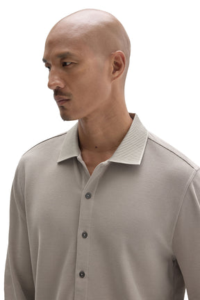 Men's close front view of a light taupe long sleeve knit button-front shirt with ribbed collar by Robert Barakett