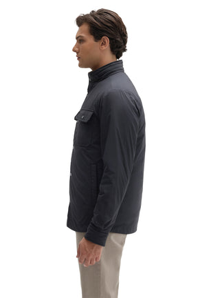Robert Barakett men's navy snap jacket with stand collar, chest flap pocket, and side hand pocket shown from the side