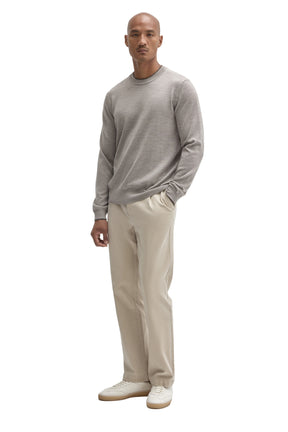 Robert Barakett men's full-body front view of a light grey crew neck long-sleeve knit sweater styled with beige pants