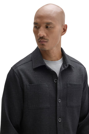 Men's close front detail of a charcoal textured overshirt with point collar and chest patch pockets by Robert Barakett