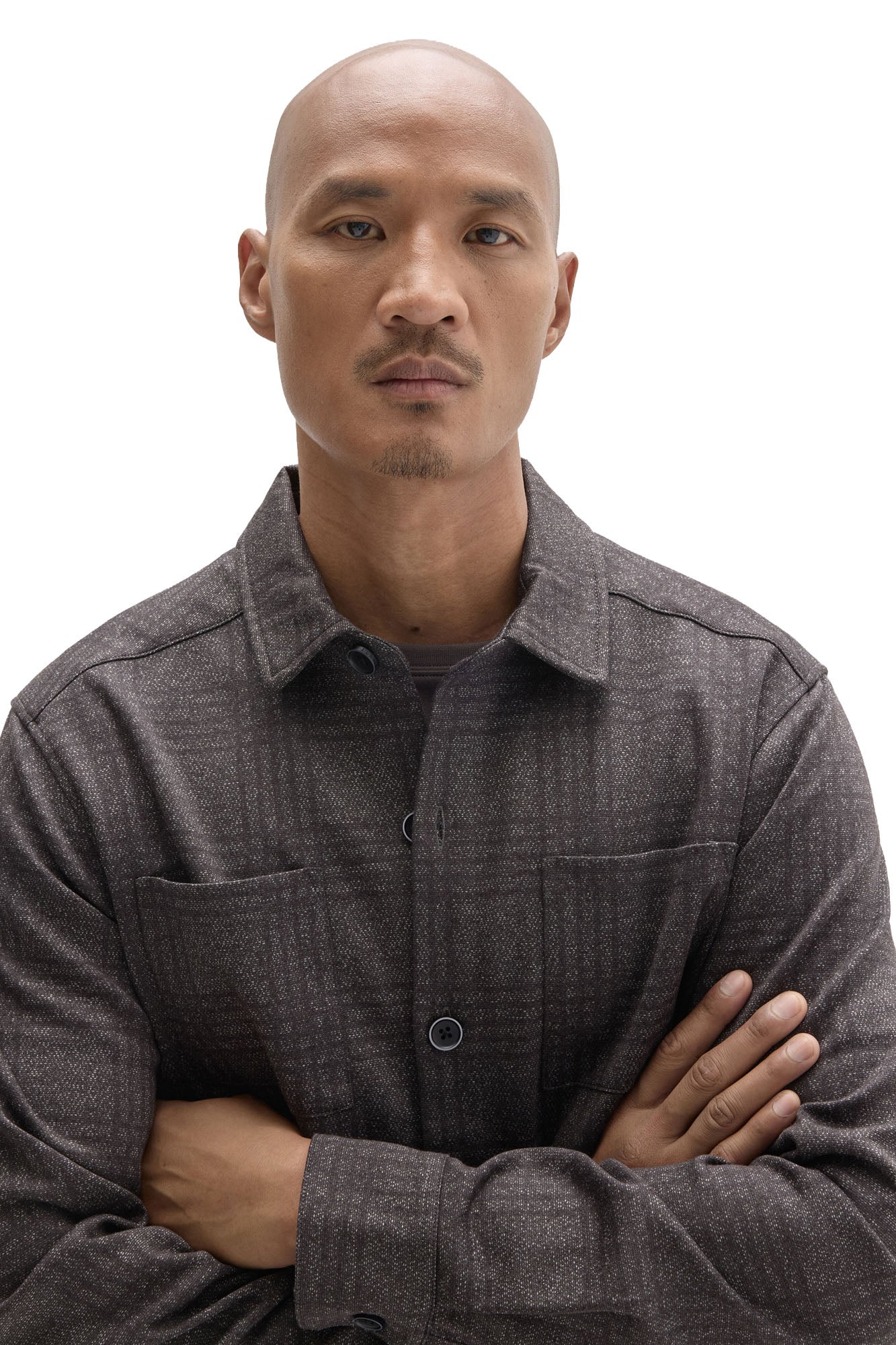 Men's close detail of charcoal plaid overshirt with point collar, chest pockets, and dark buttons by Robert Barakett