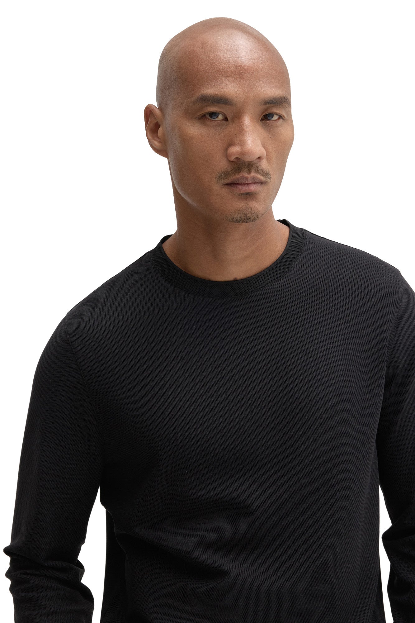 Men's close-up front view of black long sleeve T-Shirt with crew neck and fine textured knit surface by Robert Barakett