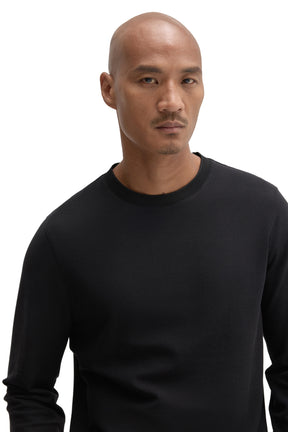 Men's close-up front view of black long sleeve T-Shirt with crew neck and fine textured knit surface by Robert Barakett
