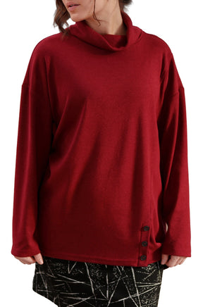 Women's angled front view of deep red tunic showing cowl neck and three black side buttons by Rien ne se perd, tout se crée