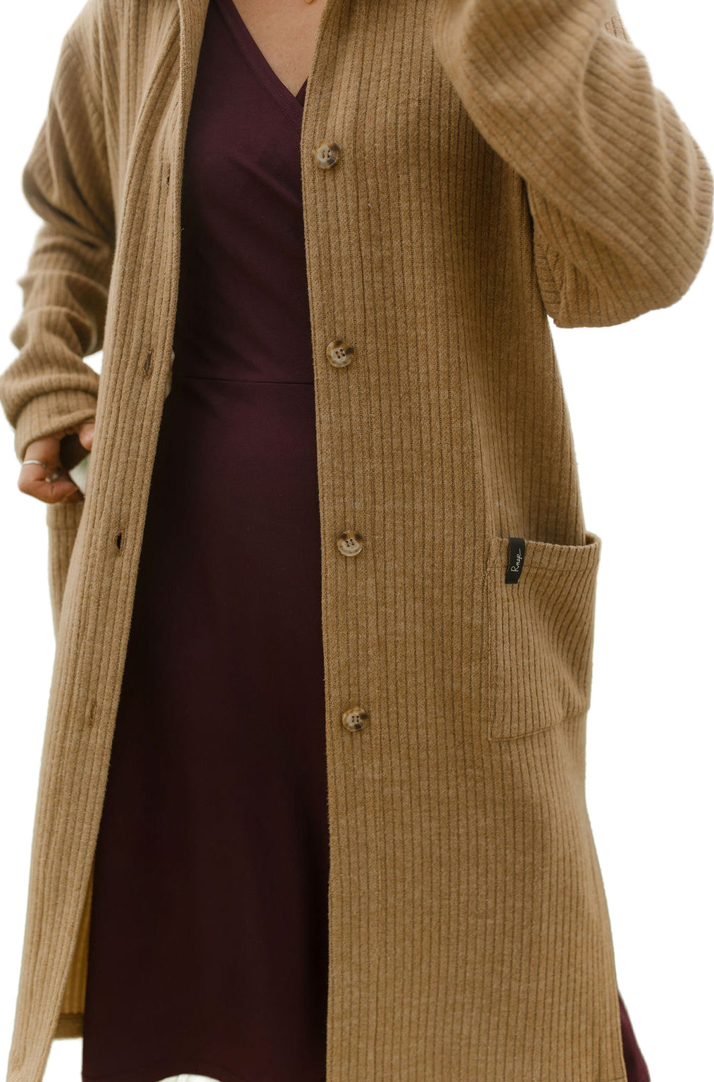 Rien ne se perd, tout se crée women's close front view of camel ribbed long jacket worn open with buttons and patch pocket