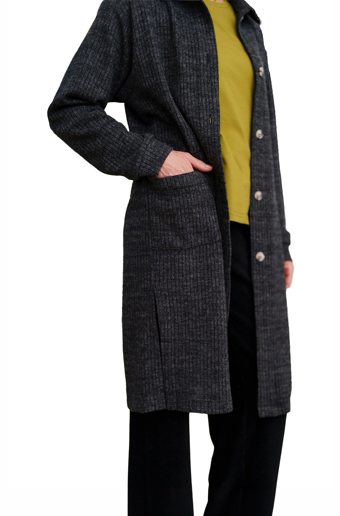 Women's side detail of charcoal ribbed long jacket showing patch pocket and button placket by Rien ne se perd, tout se crée