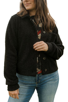 Front view of women's black nubby sherpa jacket with collar, buttons, and patch pockets by Rien ne se perd, tout se crée