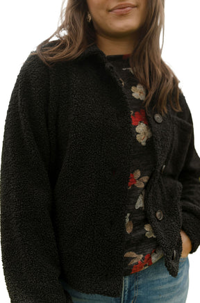 Rien ne se perd, tout se crée women's close front angled view of a black sherpa jacket worn open showing collar, side view