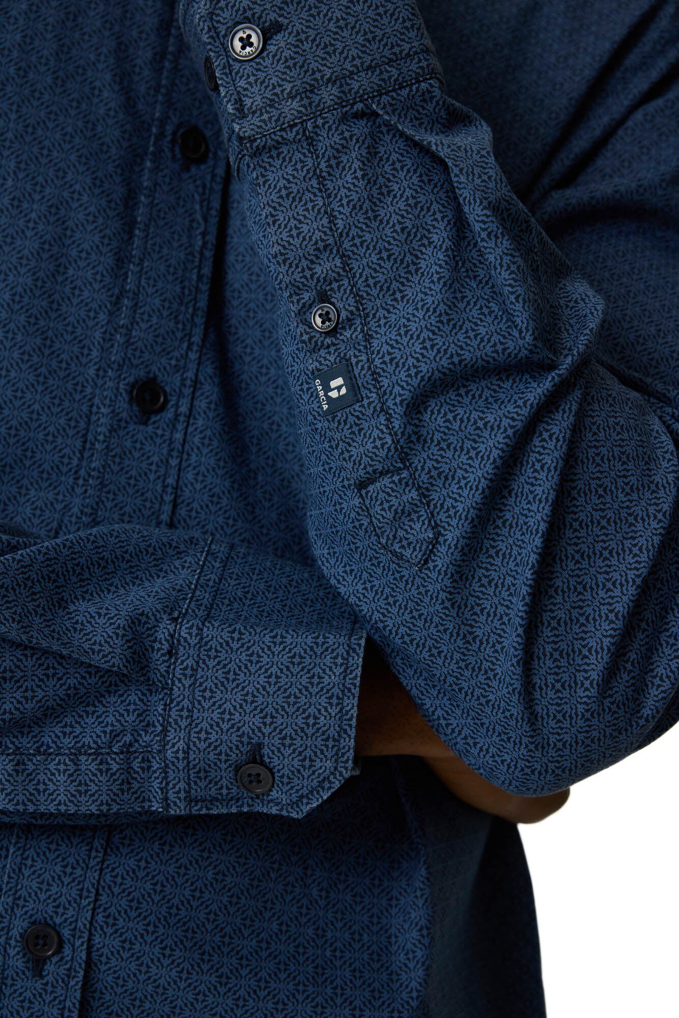 Gros plan du poignet boutonné de la chemise manches longues bleue foncé à micro motif pour homme par Garcia